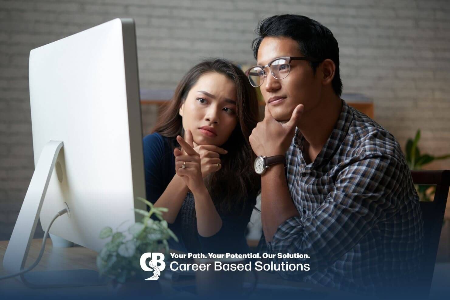  Two ABA therapists analyzing data on a computer, representing the role & responsibilities of an RBT