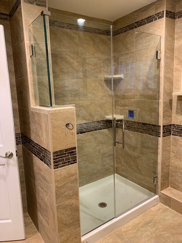A bathroom with a walk in shower and a toilet.