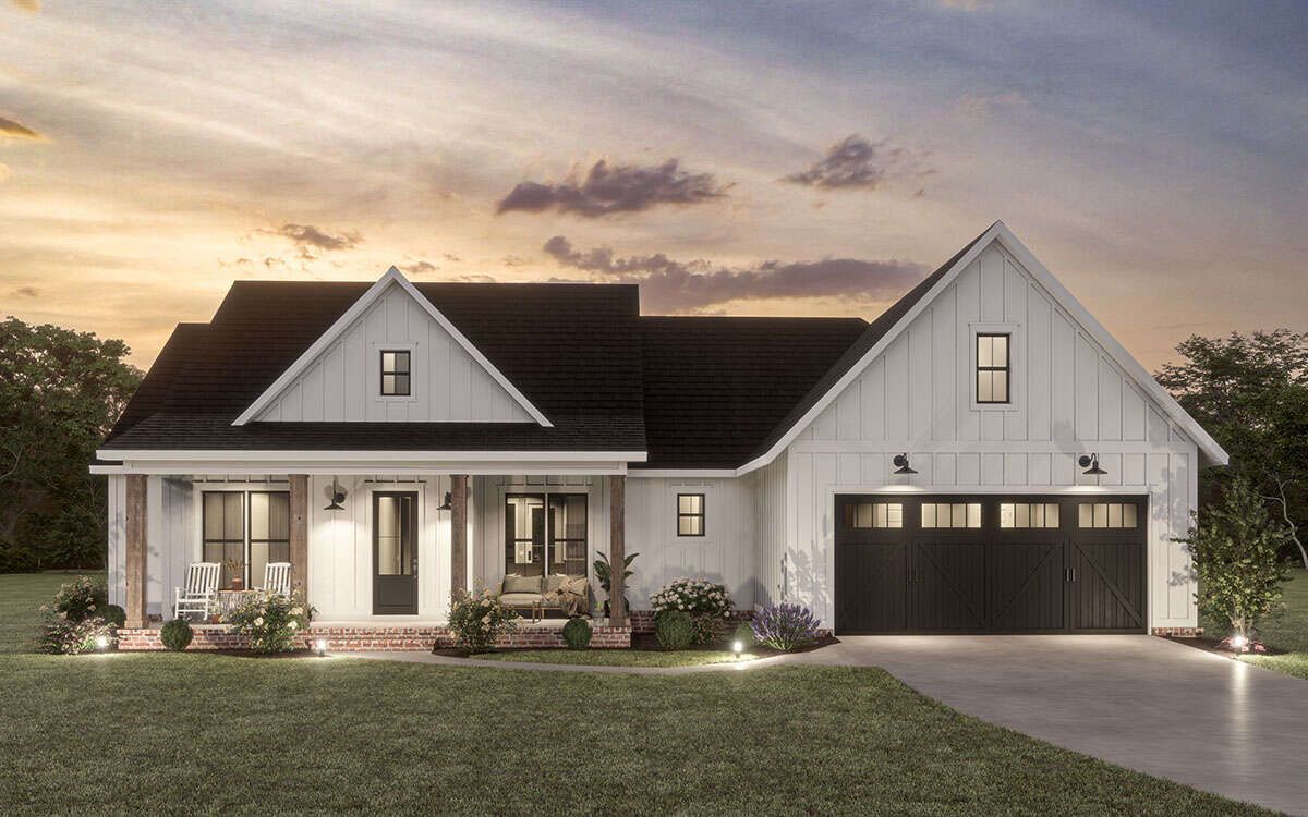A white house with a black roof and a black garage door.