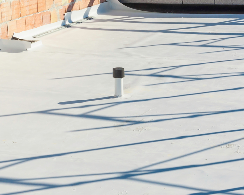 a white roof with a black pipe on top of it .