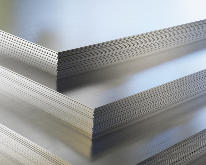 three sheets of metal are stacked on top of each other .