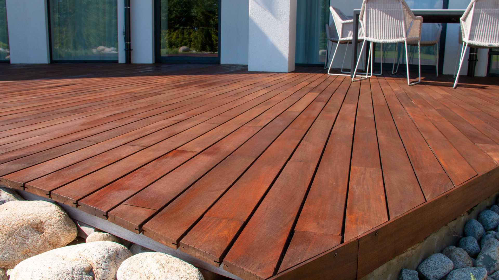 a wooden deck with a table and chairs on it