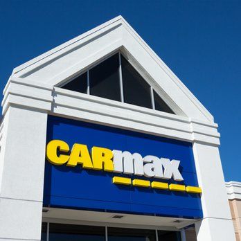 A carmax store with a blue and yellow sign