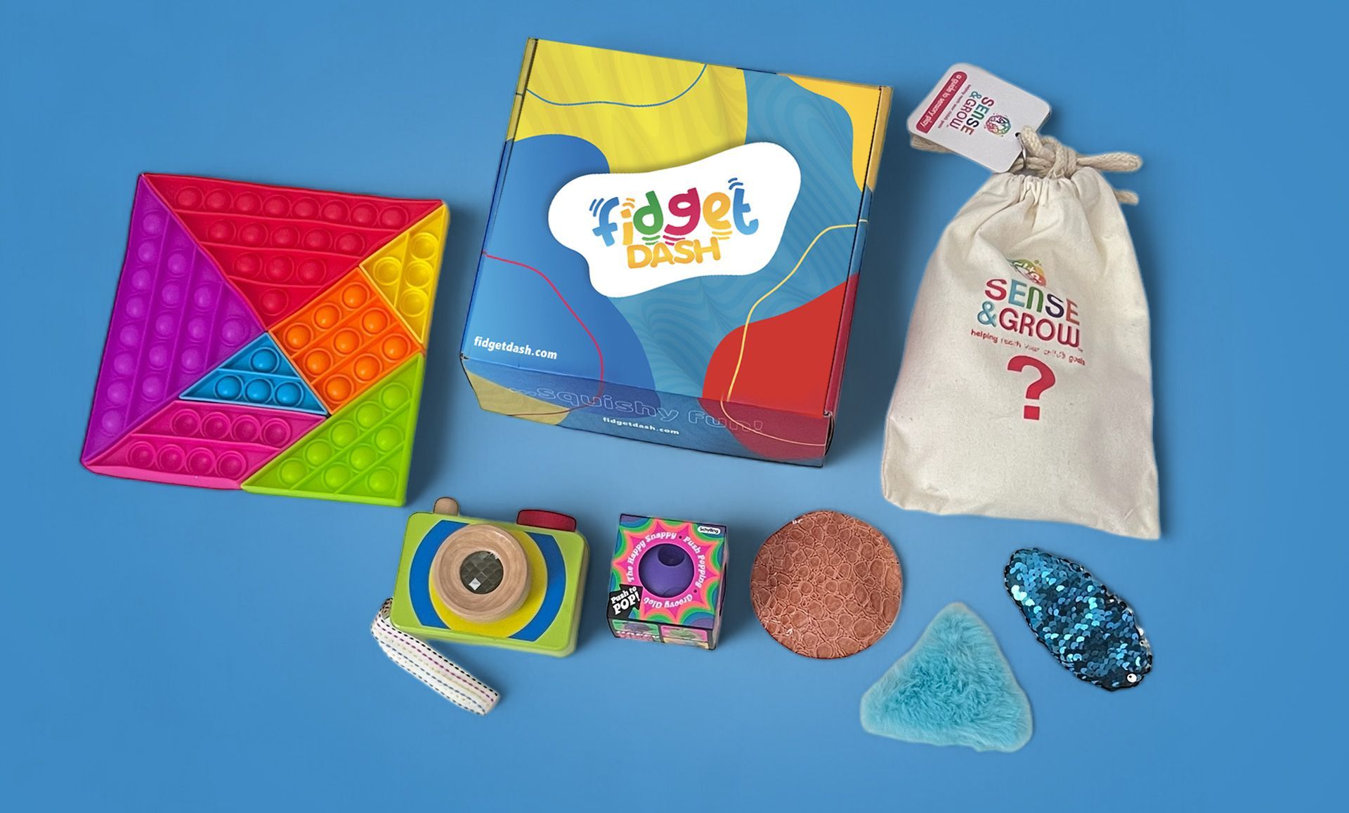 A box of fidget toys is sitting on a blue table.