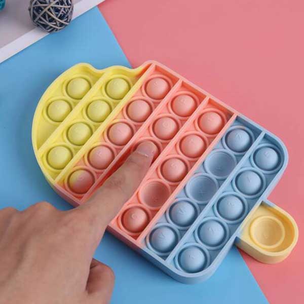 A person is playing with a pop it in the shape of an ice cream cone.