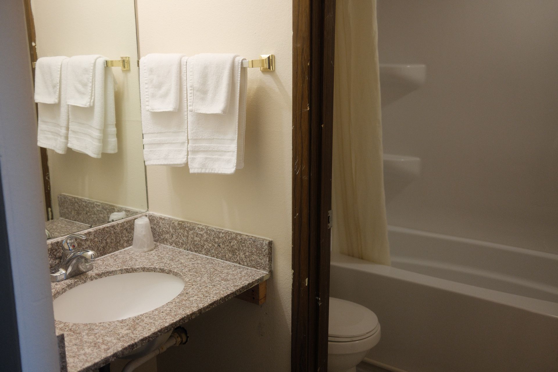A bathroom with a sink , toilet , and bathtub.