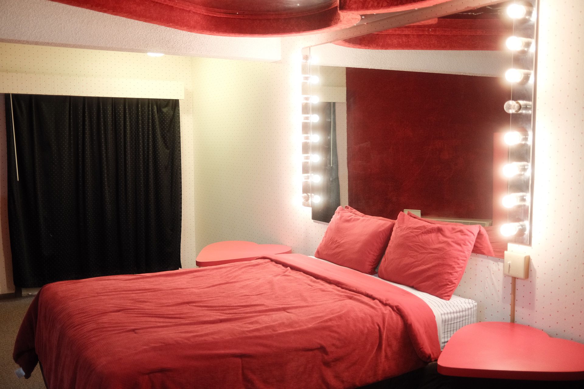 A hotel room with a bed and a mirror