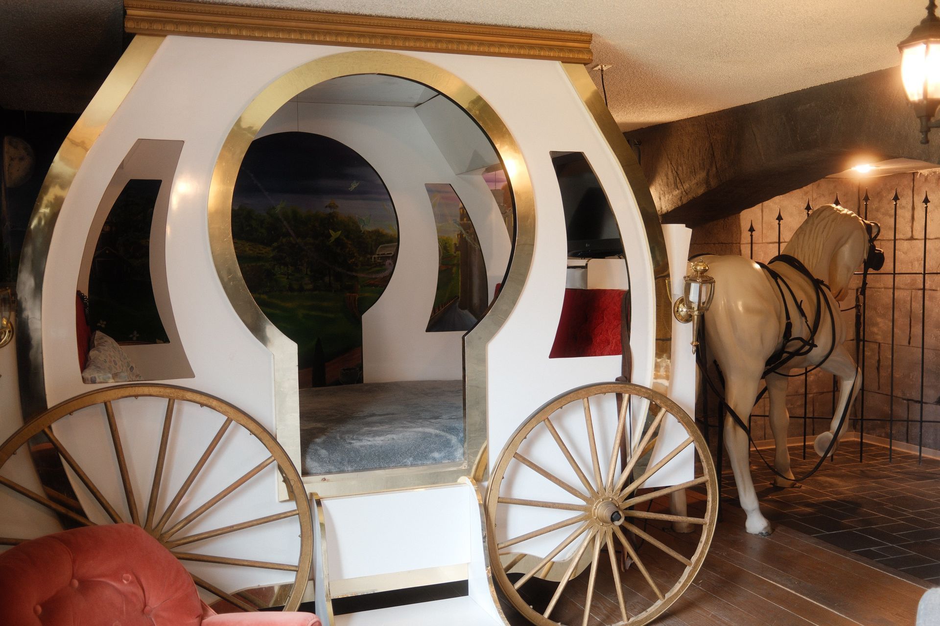 A bed in the shape of a horse drawn carriage