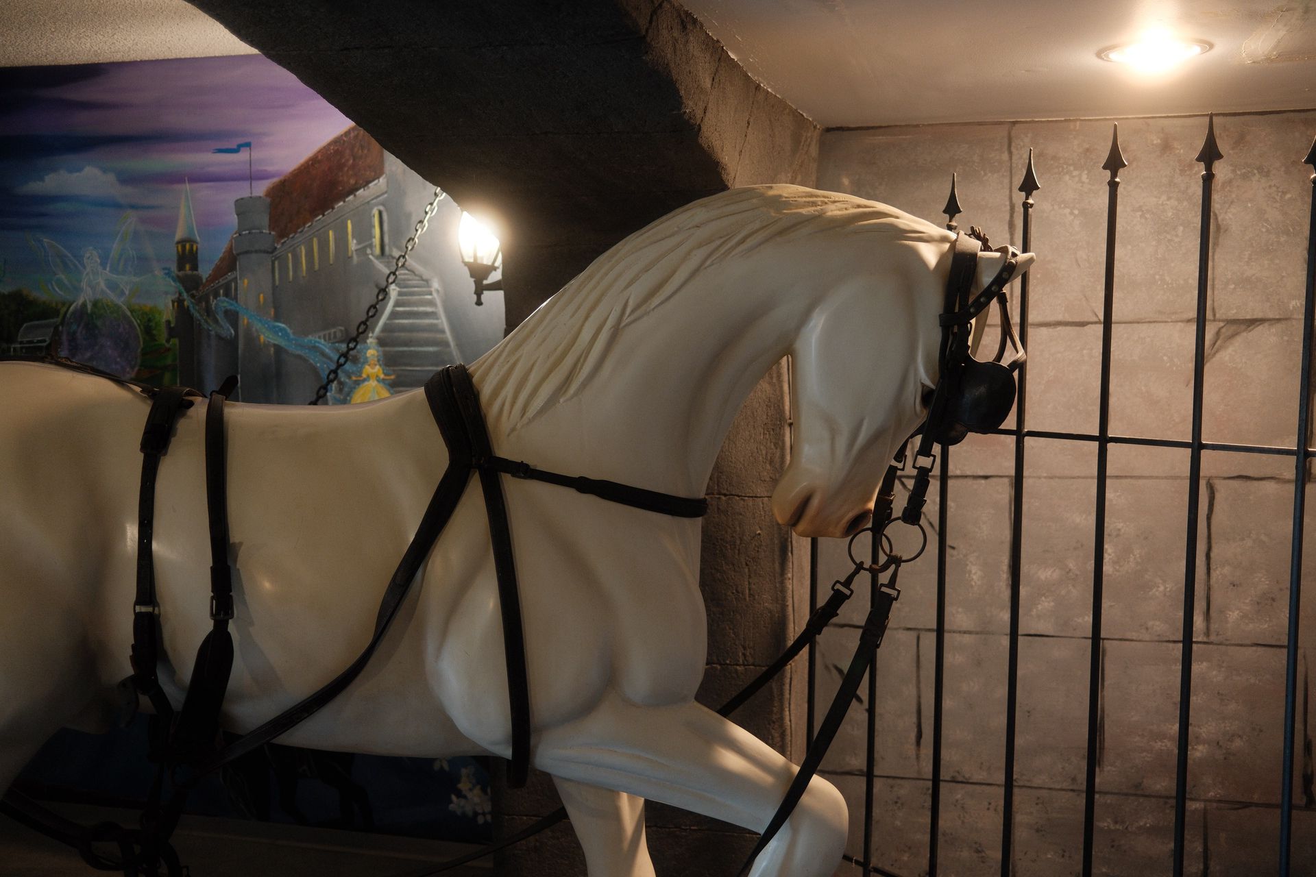 A statue of a white horse with a black harness