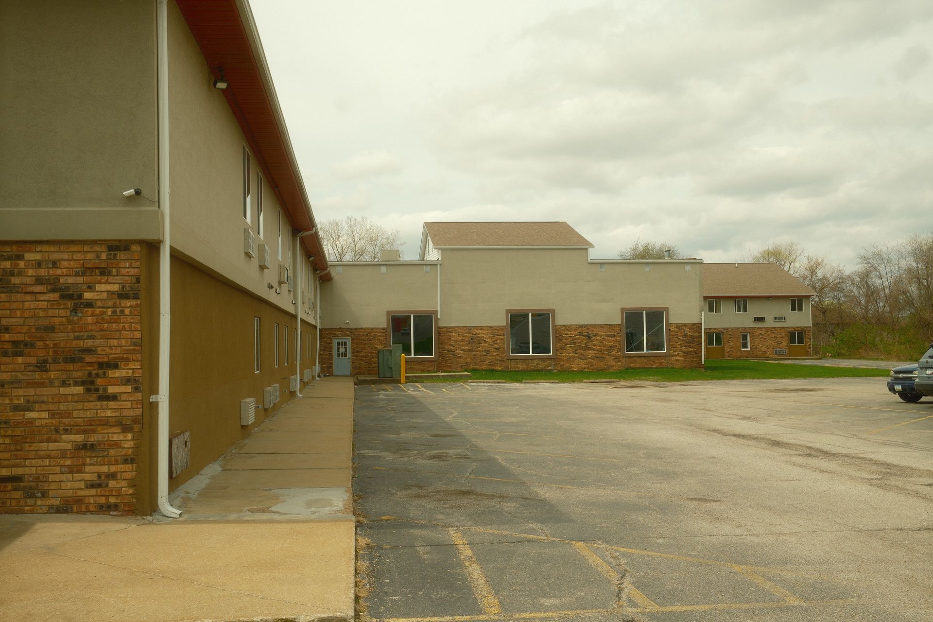 A brick building with a parking lot in front of it