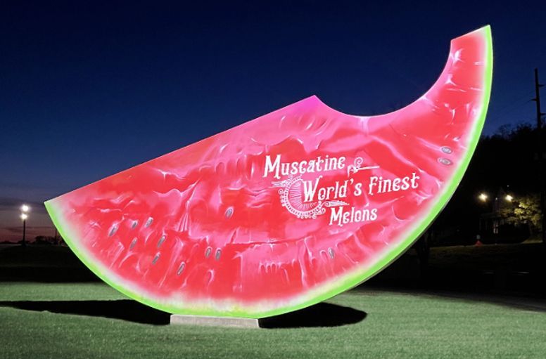 A large slice of watermelon with muscatel world 's finest melons written on it