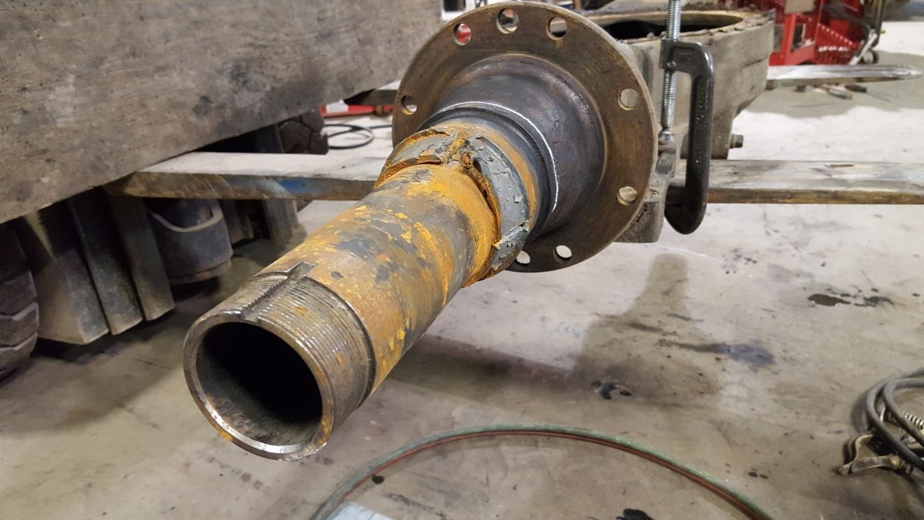 A close up of a metal pipe in a garage.