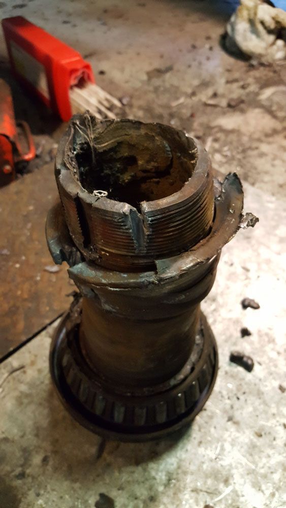 A close up of a broken bearing on a table.