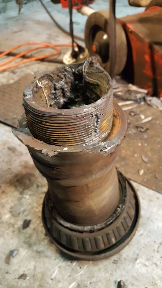 A close up of a piece of metal sitting on top of a table.