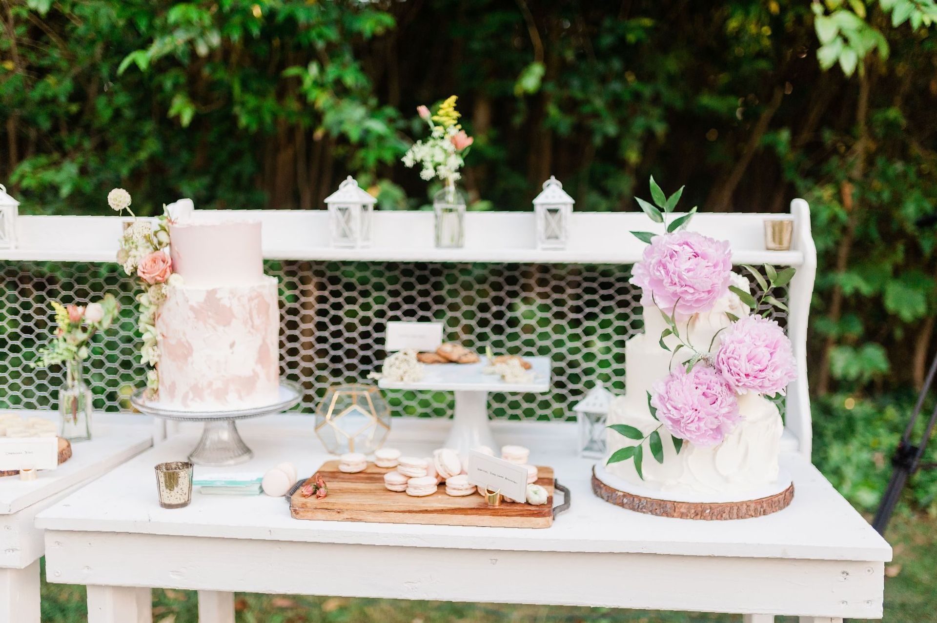 rustic dessert table with various cakes and treats