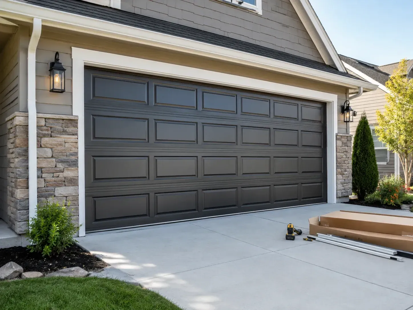 Black residential garage door installation on a home in Roscoe IL