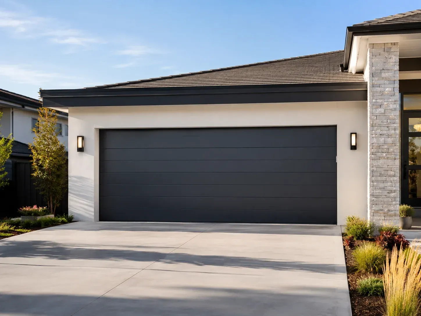 Modern black garage door on a clean residential home exterior in Roscoe IL