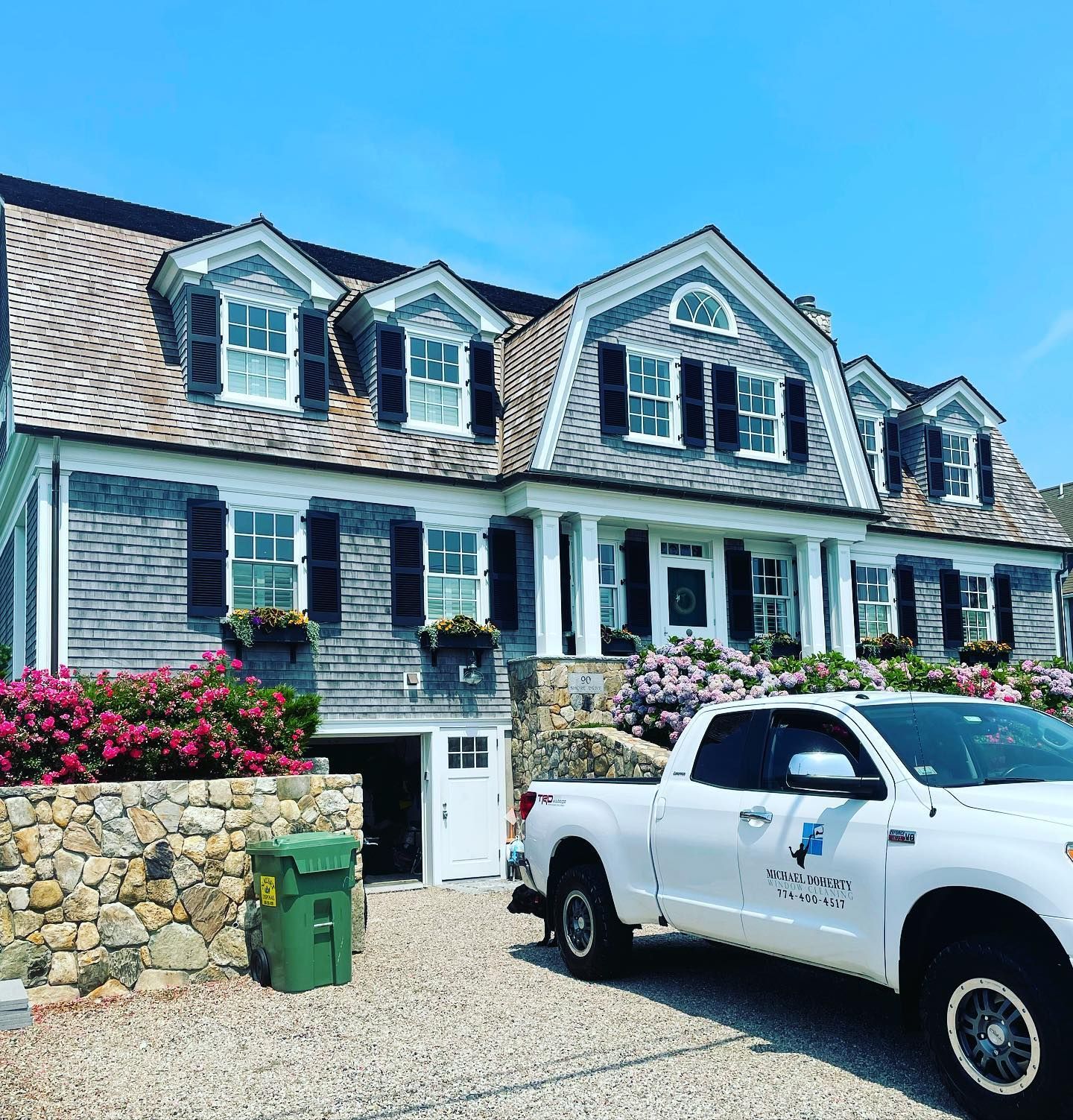 Elegant Cape Cod home with white trim and clean windows by Michael Doherty Window Cleaning