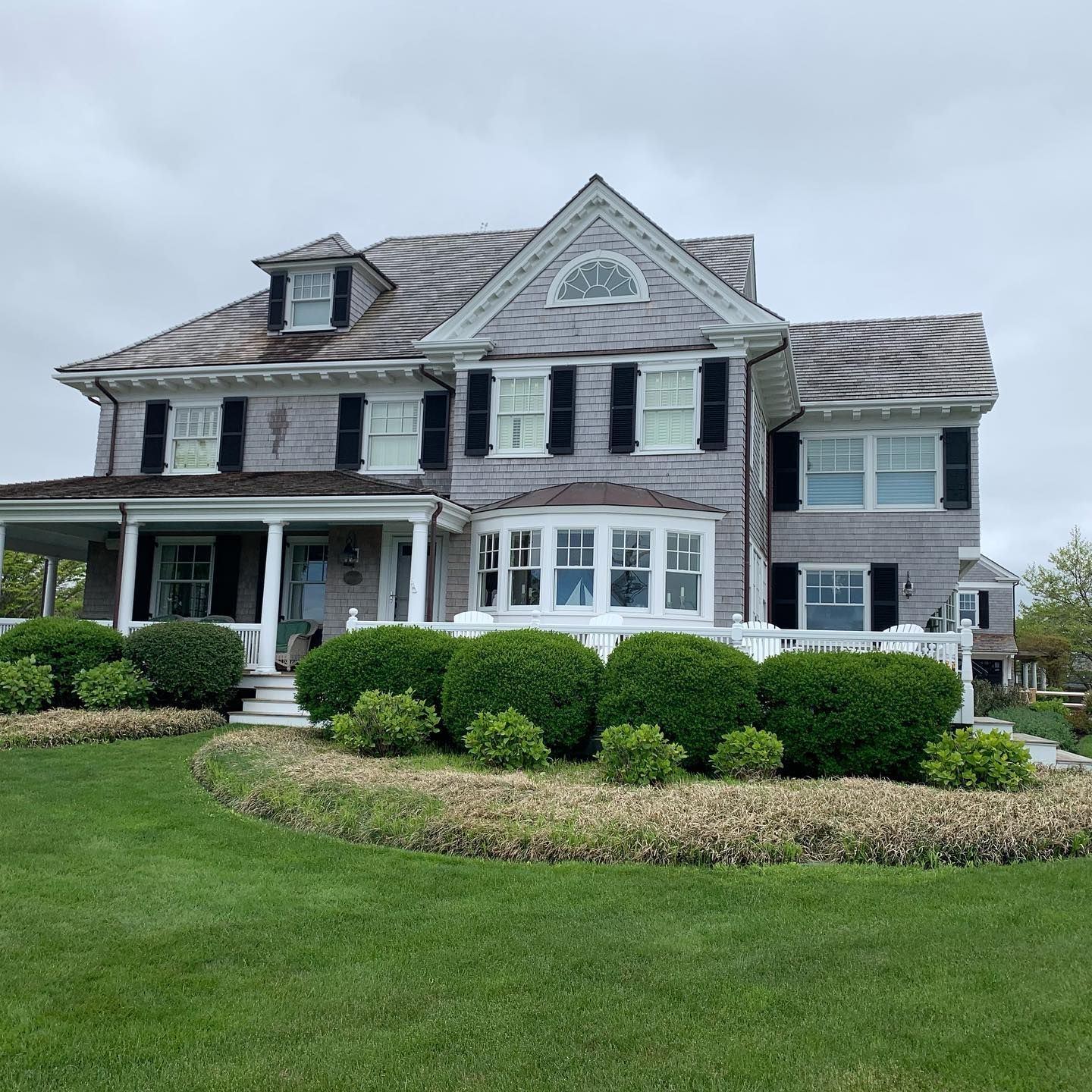 A large house with a large lawn in front of it