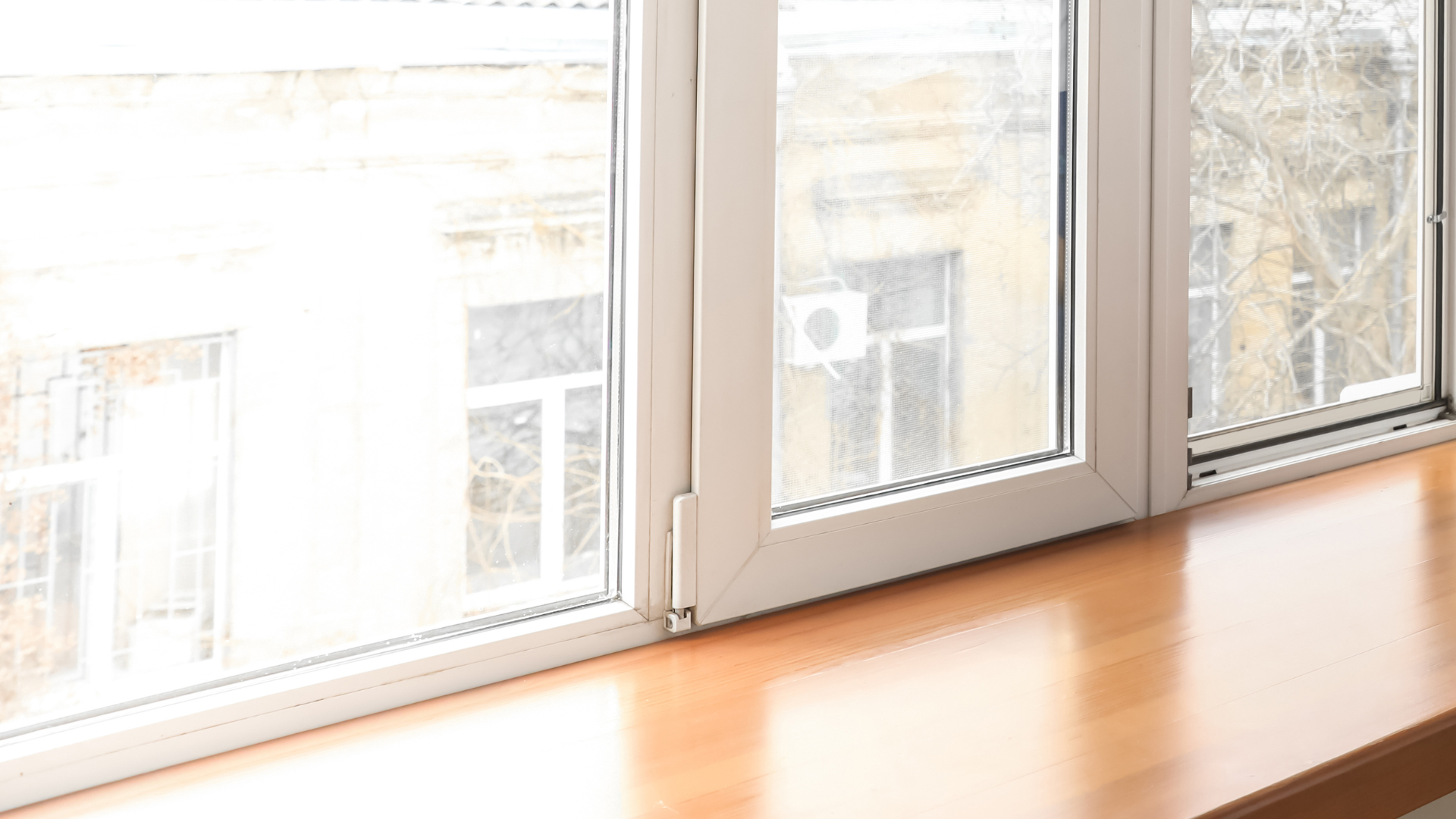 A close up of a window with a wooden sill.