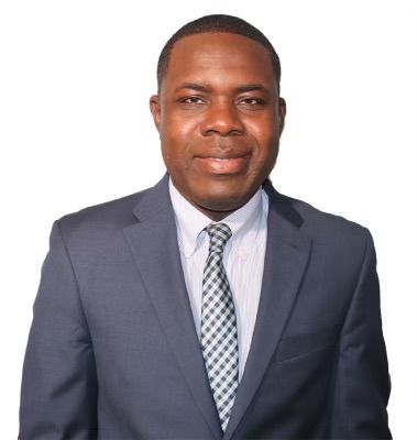 A man in a suit and tie is smiling for the camera