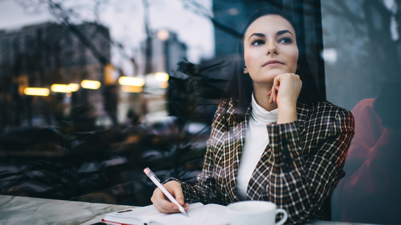 A woman is sitting on a couch talking to a man.