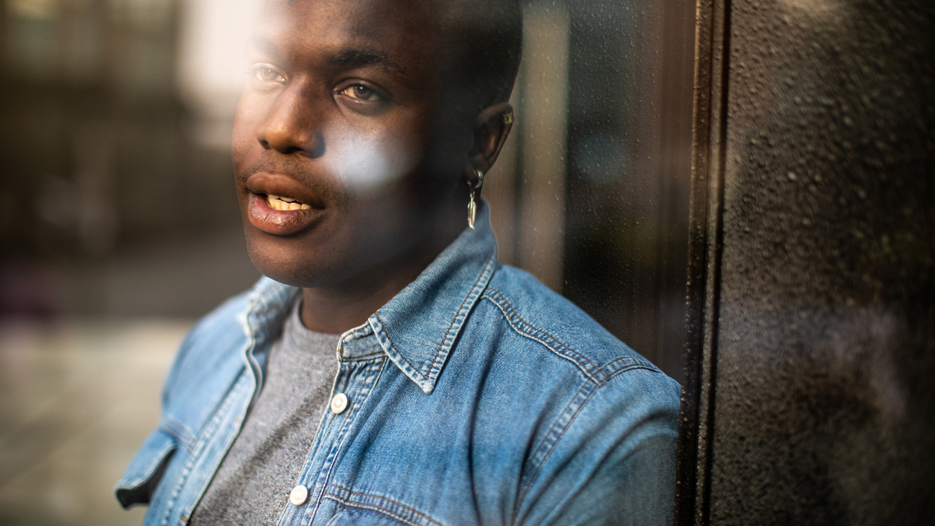 A woman is smiling and crying in a black and white photo.