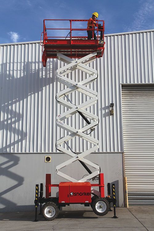 Orange scissor lift with platform raised; ready for workers.