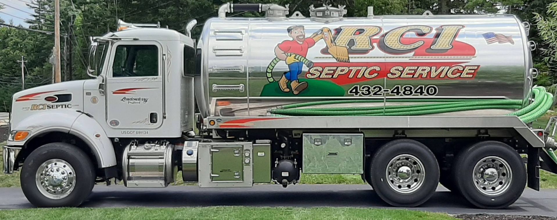 A septic service truck is parked on the side of the road.