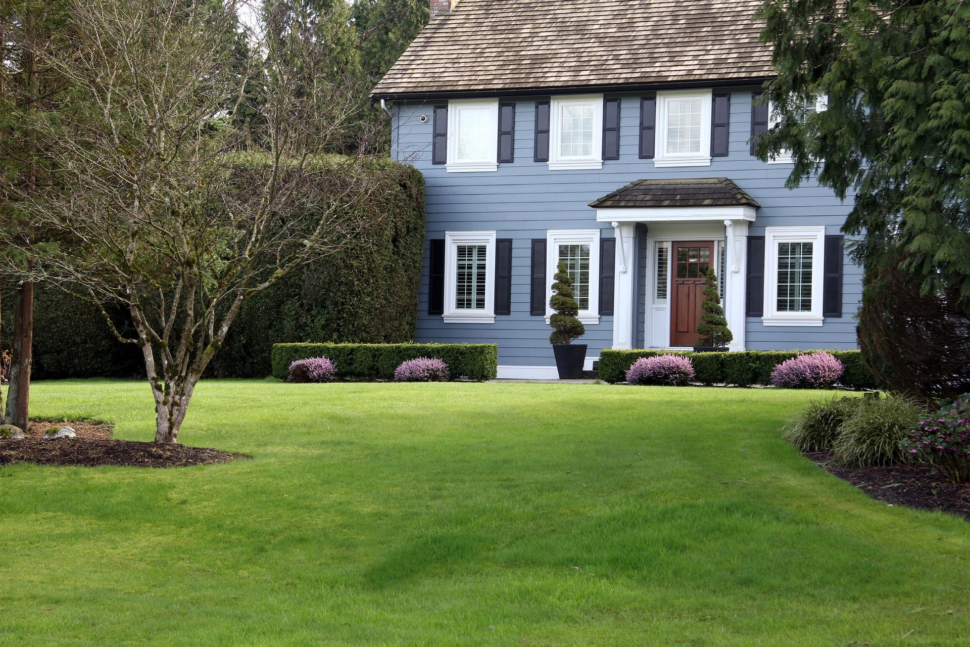A large house with a lush green lawn in front of it