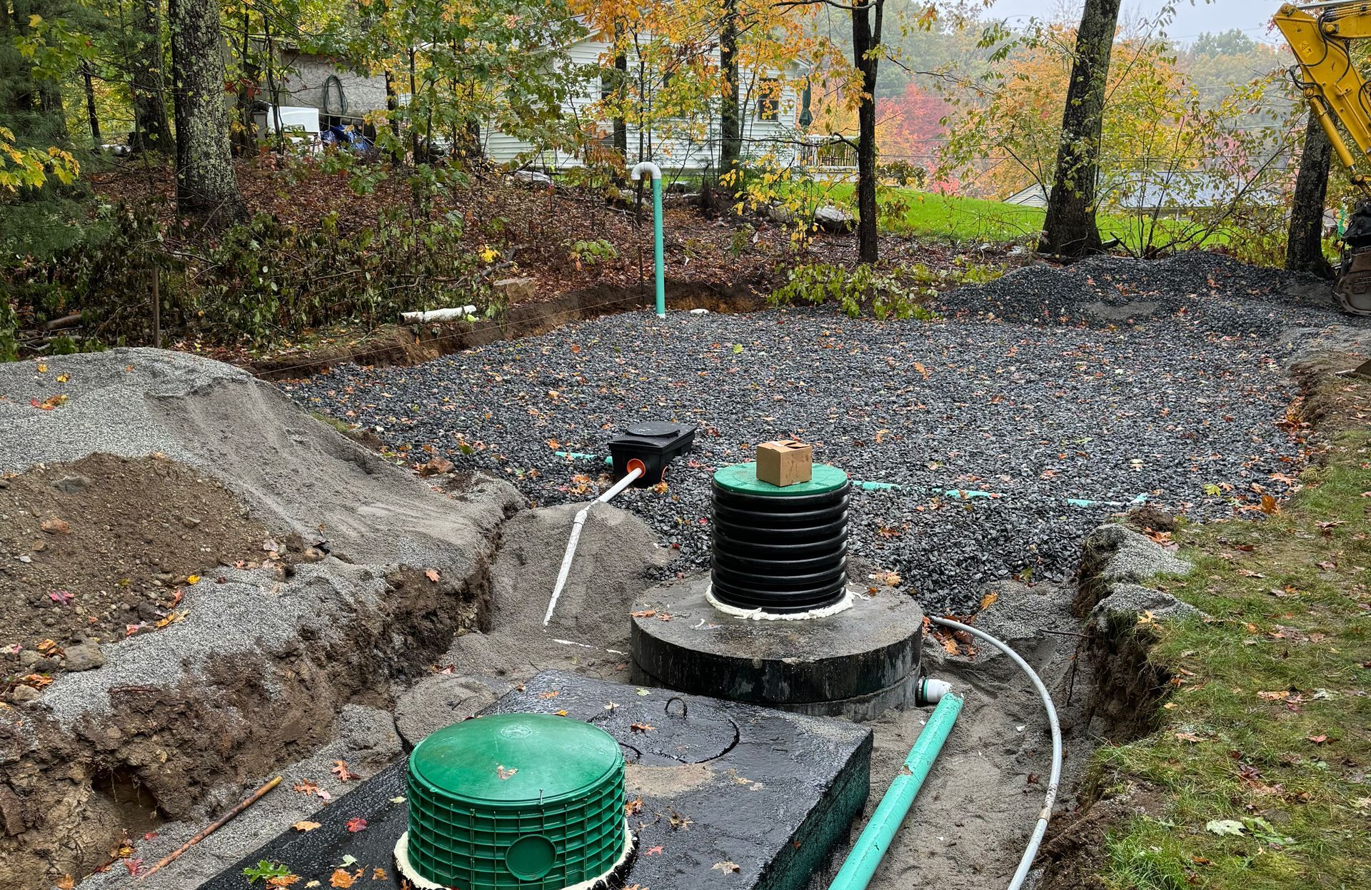 A septic system is being installed in a backyard.