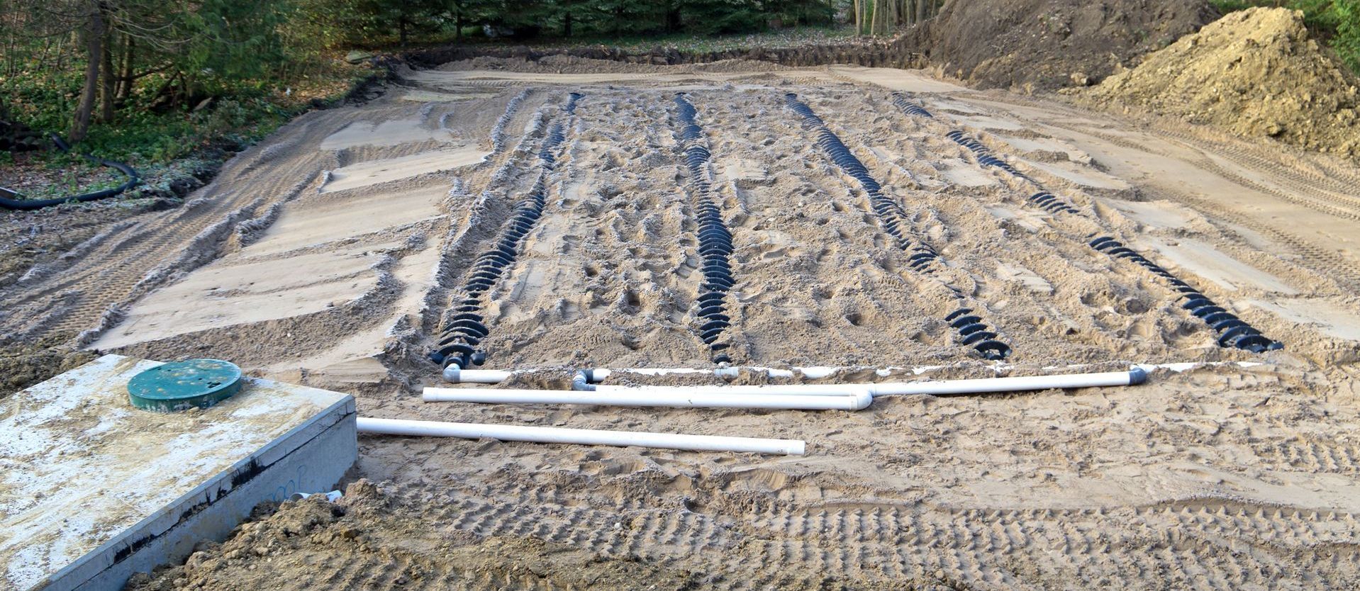 a septic system is being installed in a dirt field