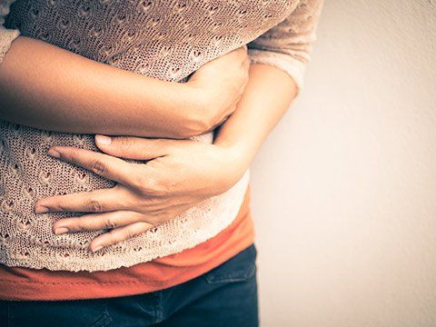 Woman suffering from diverticulitis