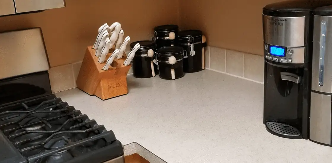 A kitchen with a stove and a coffee maker