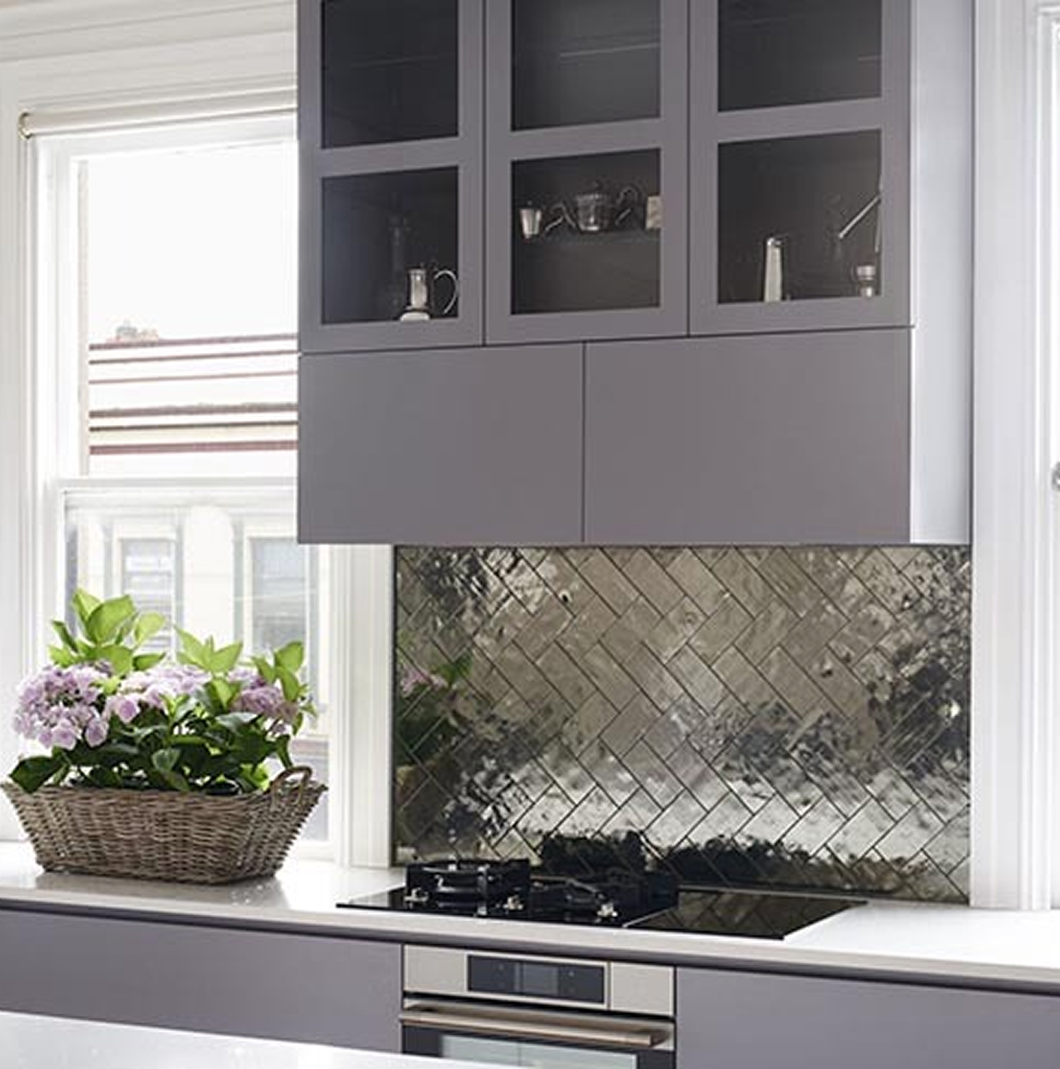 A kitchen with a basket of flowers on the counter