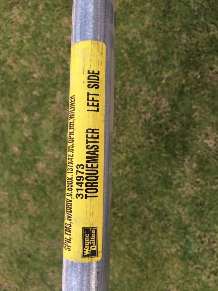 A yellow sticker on a metal pole says torquemaster left side