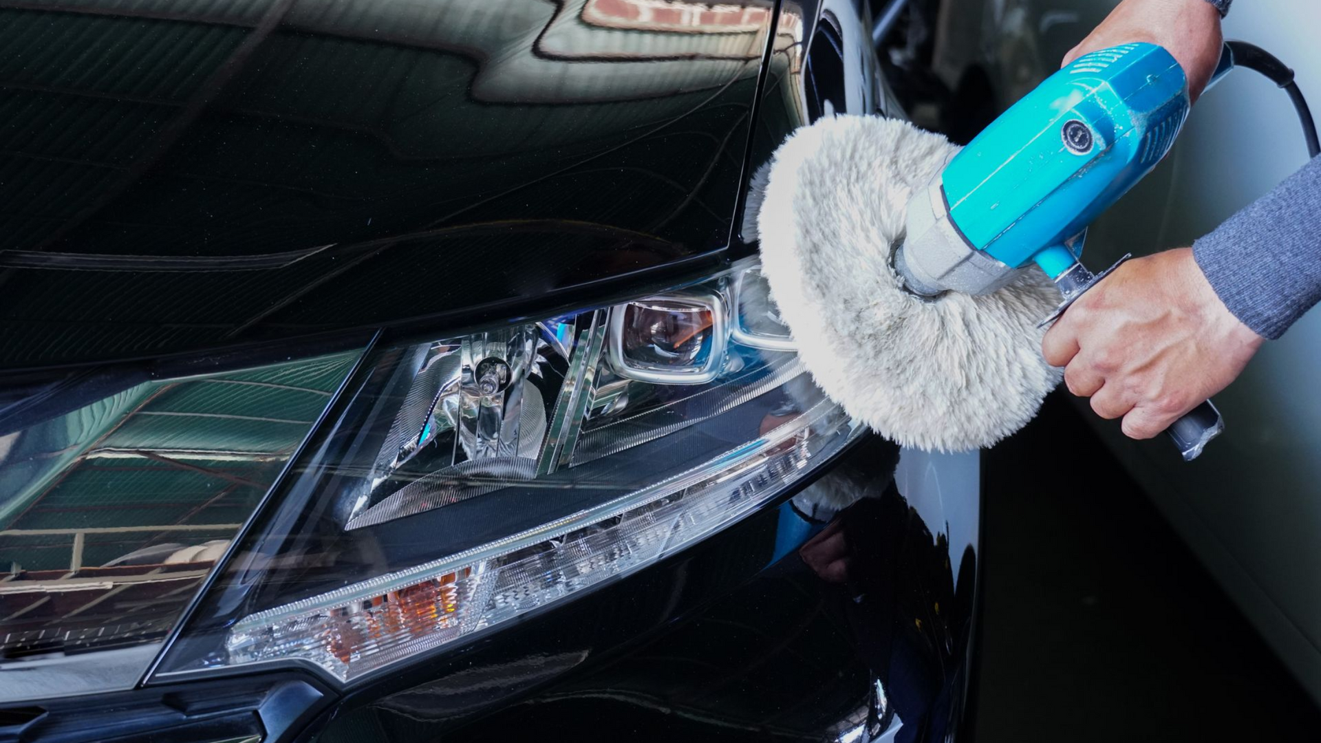 A close up of the headlights of a black car