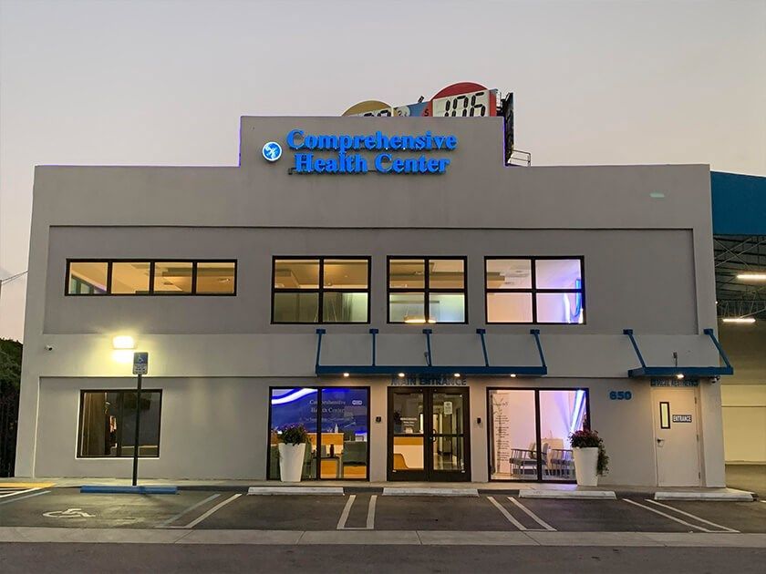 Exterior view of Comprehensive Health Center building with blue signage.