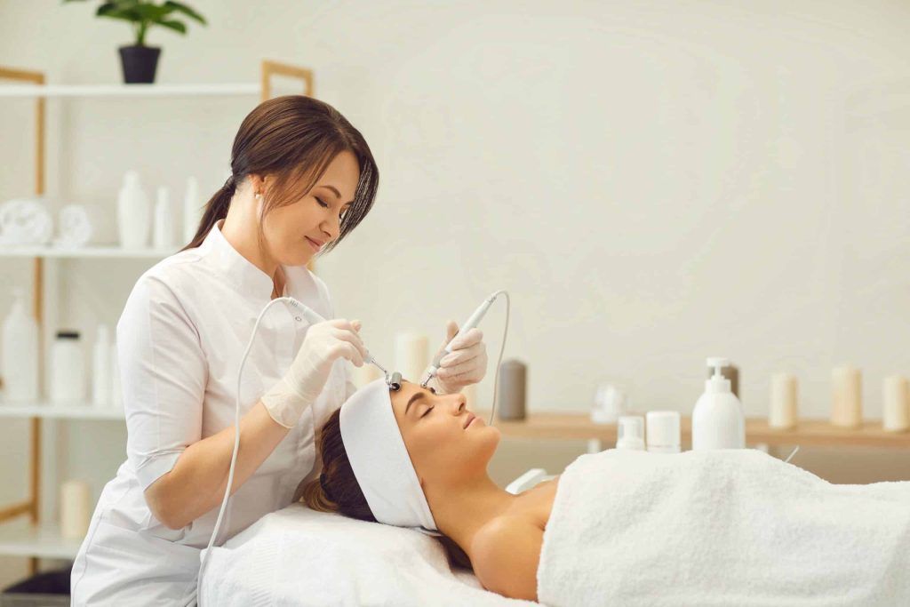 A woman is getting a facial treatment at a beauty salon.