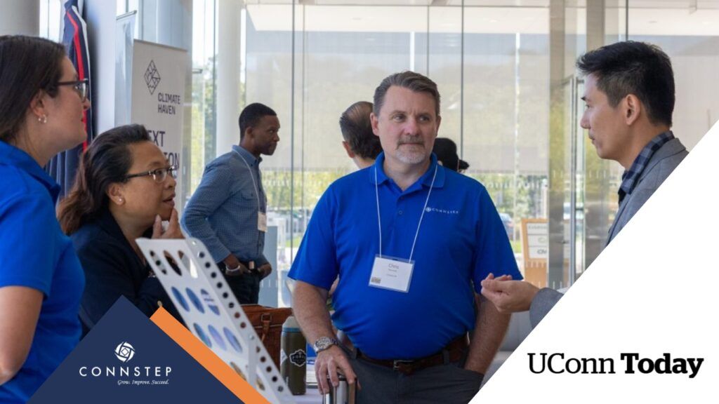 People in blue shirts talking at a conference, UConn Today logo.