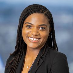 A portrait of Phoebe Gonzales, Business Development Advisor at CONNSTEP, smiling, wearing a black blazer, against a blurred background.