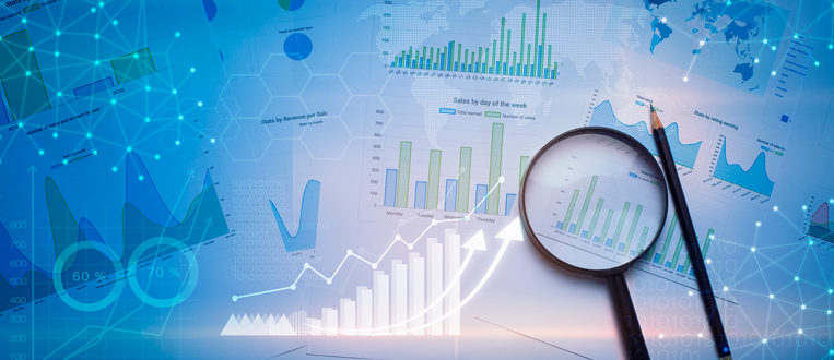 Magnifying glass and pencil over a financial chart with data analysis.