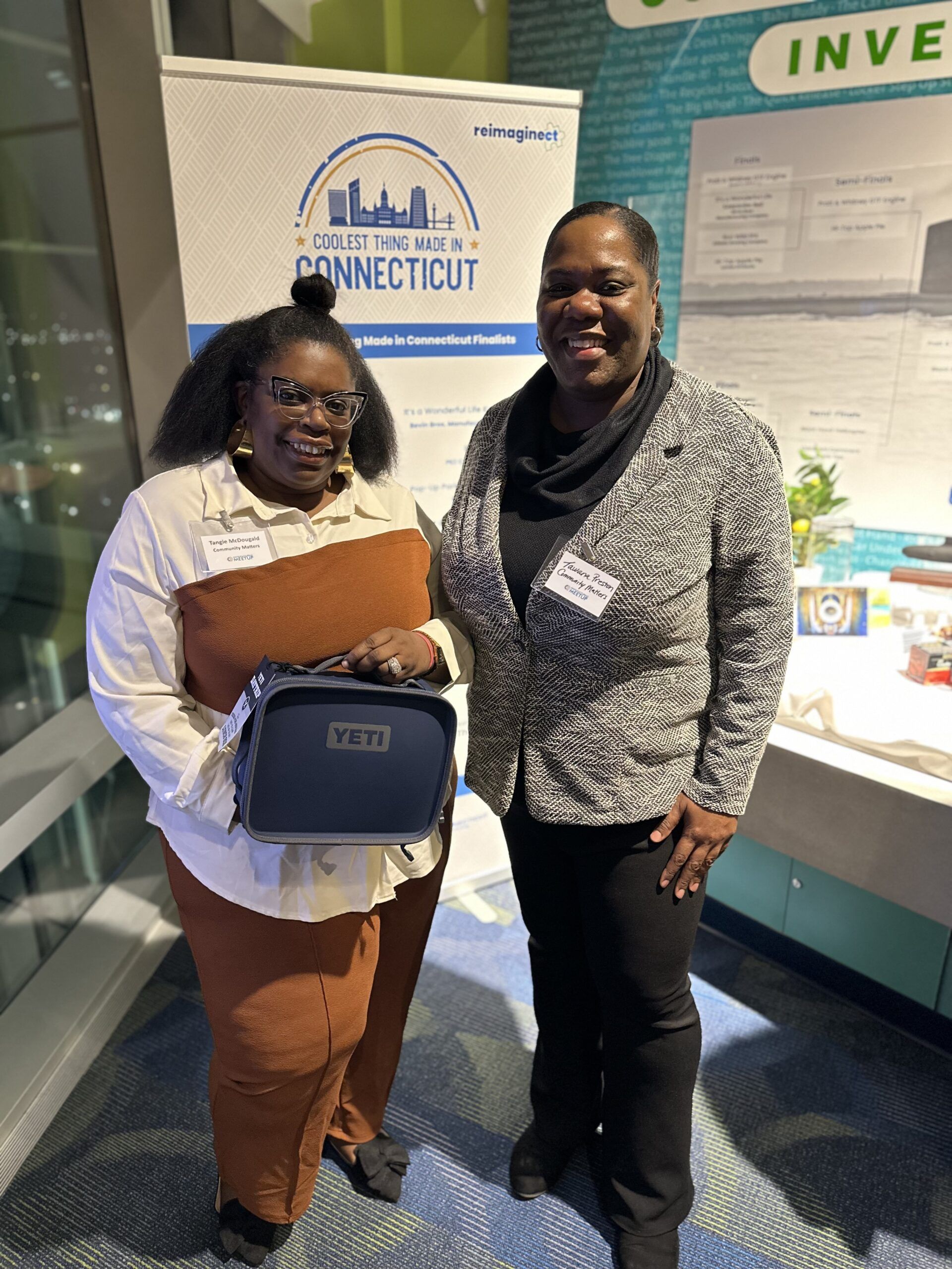 Two women posing near a 