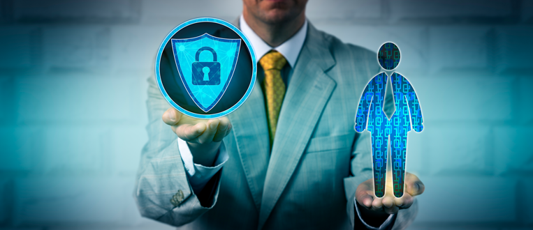 A person in a suit holding a shield with a lock icon and a human figure, symbolizing security and protection.