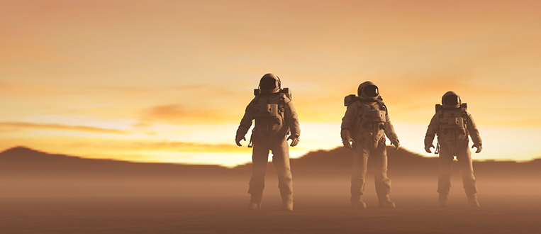 Three astronauts standing on a reddish planet, gazing at the horizon with an orange sky and mountains.