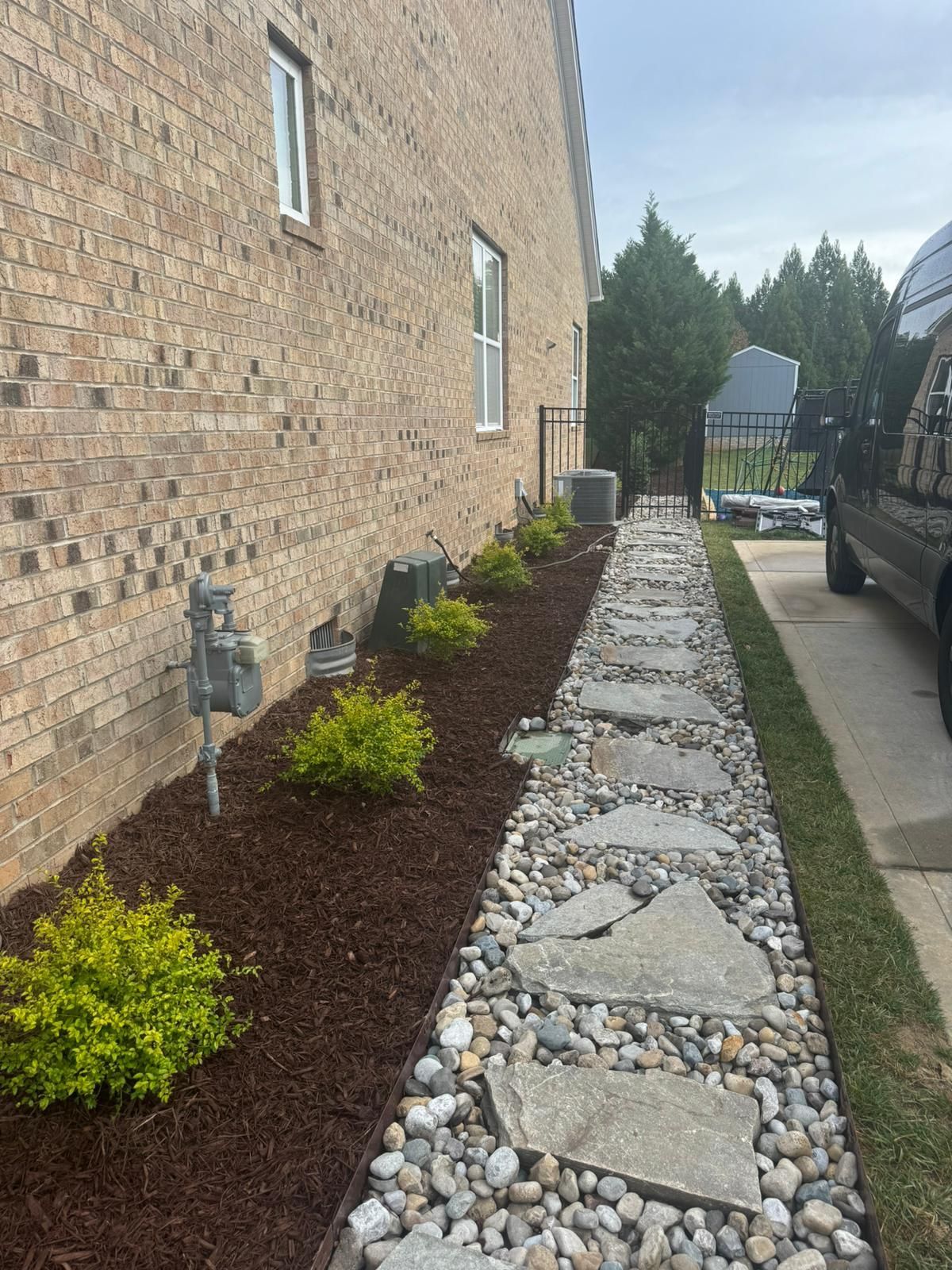 A brick building with a stone walkway leading to it.
