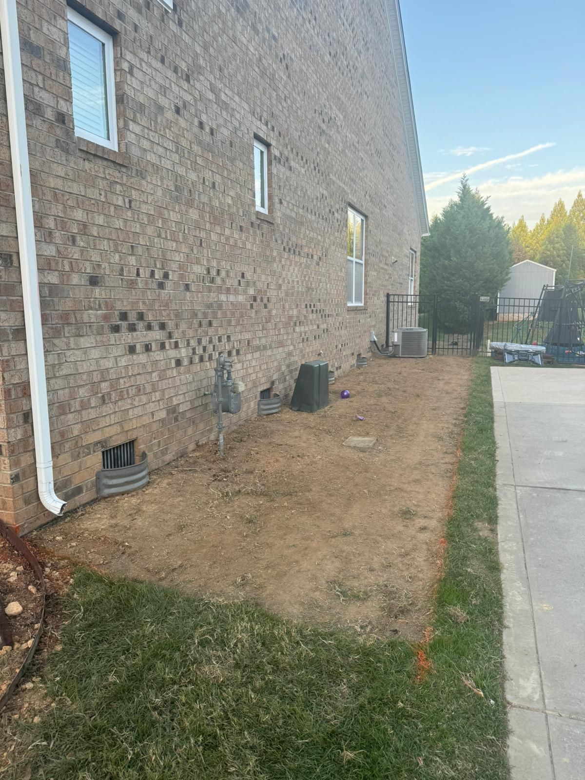 A brick building with a lot of dirt in front of it.