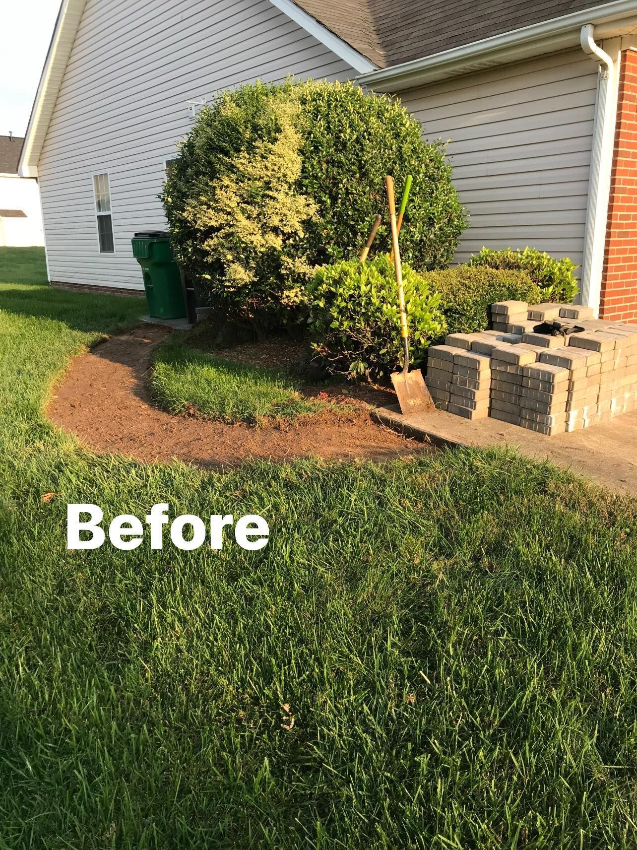 A before picture of a lawn in front of a house.
