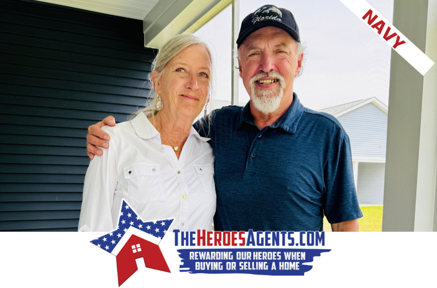 A man and a woman are posing for a picture in front of a house ..