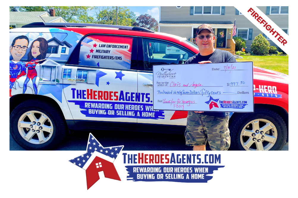 A man holding a check in front of a firefighter vehicle